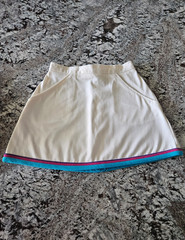 WOMEN’S WHITE TENNIS SKIRT WITH BLUE, PINK, AND PURPLE TRIM IN SIZE 7/8