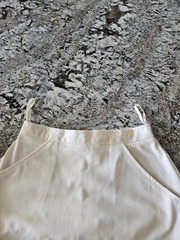 WOMEN’S WHITE TENNIS SKIRT WITH BLUE, PINK, AND PURPLE TRIM IN SIZE 7/8
